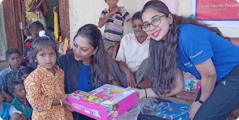 Child getting a gift from two woman