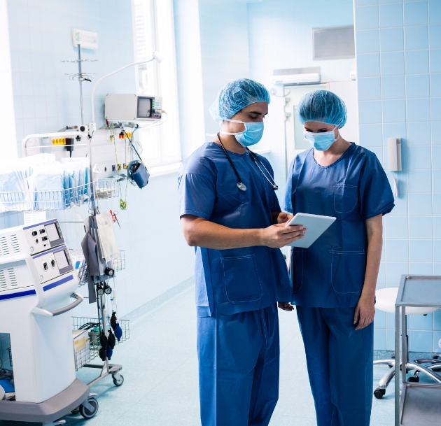 image of two doctors having a discussion over a notepad