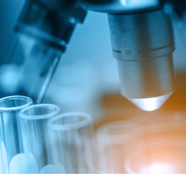 image of microscope looking into test tubes