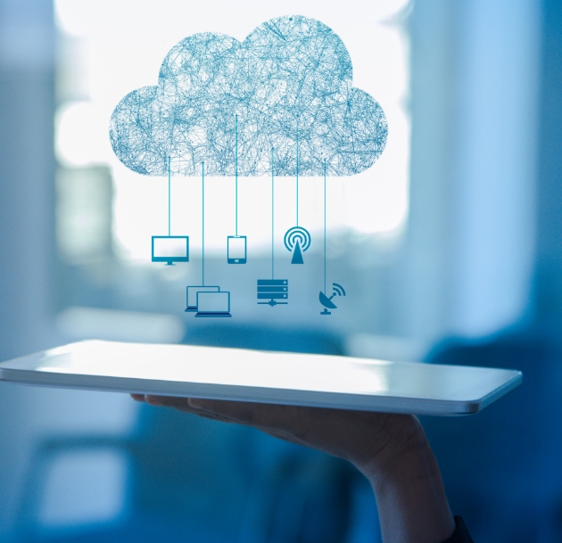 artistic image of a cloud mobile with computer monitors hanging from it over a tablet