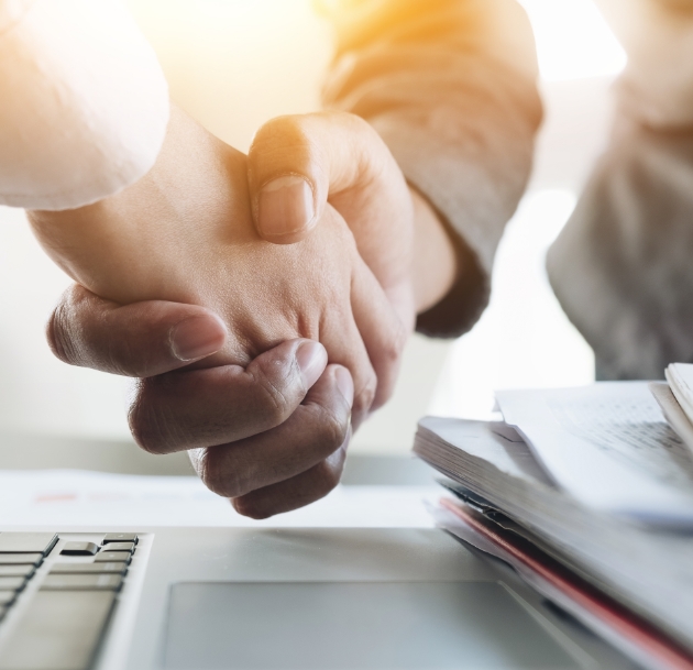 Handshake over a laptop