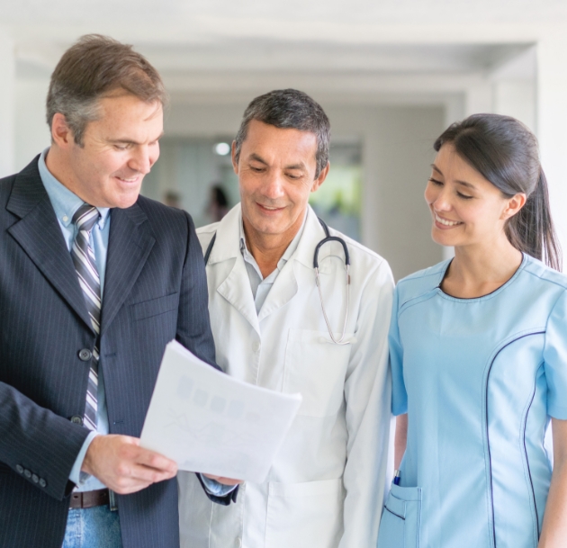 Business person showing doctors a paper